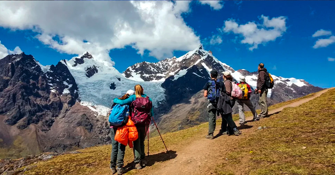 Group of hikers arriving at Machu Picchu after completing the Lares Valley Trek with Peru Grand Travel.
