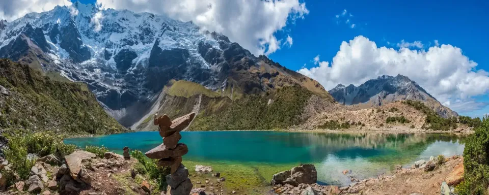 Turquoise Humantay Lake and snowy mountains. Humantay Lake with turquoise waters surrounded by snow-capped mountains in Cusco.