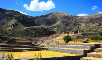 Tipon archaeological complex highlighting ancient flowing water channels and green terraces.