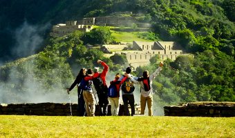 Travelers hiking along the remote mountain trail toward the Choquequirao archaeological site.